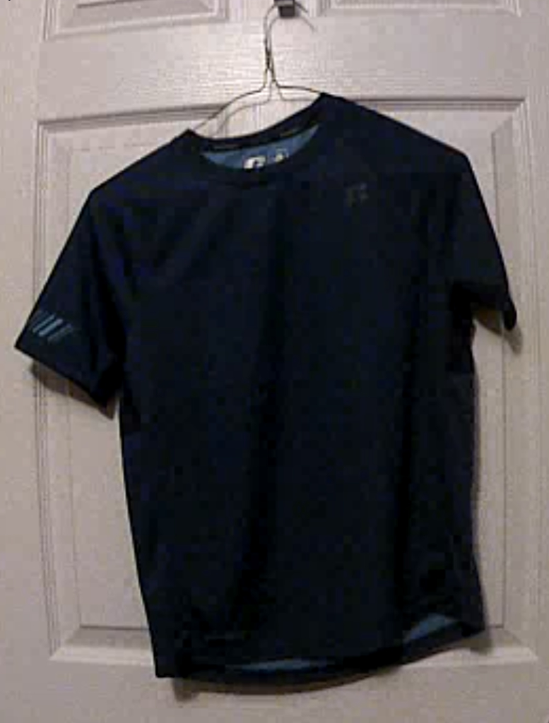 image of a dark blue colored t-shirt hanging on a door