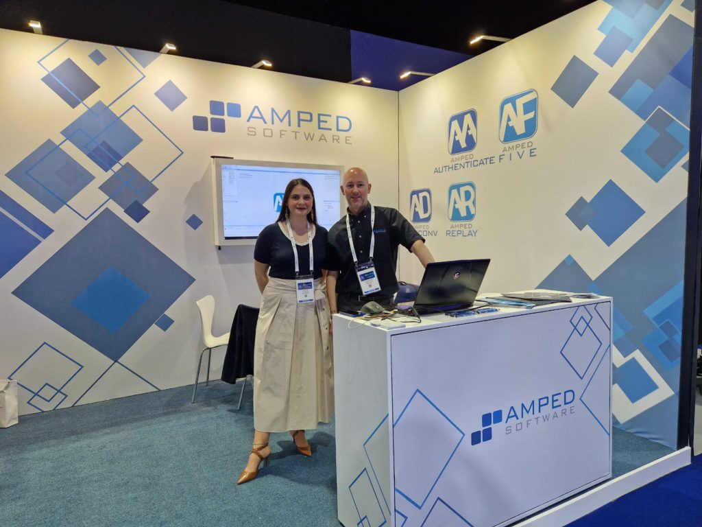 Chiara and Davis standing at Amped's booth at the World Police Summit 2023
