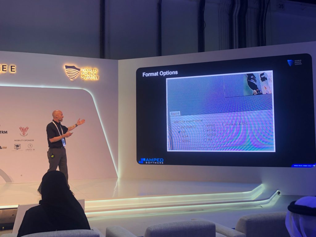 David pointing at a screen during his presentation at the World Police Summit 2023